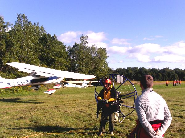 A plane landing behind Chris Miller as he prepares to launch