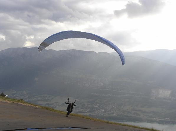 Jason Andrews launching his paraglider from Col de la Forclaz, Annecy